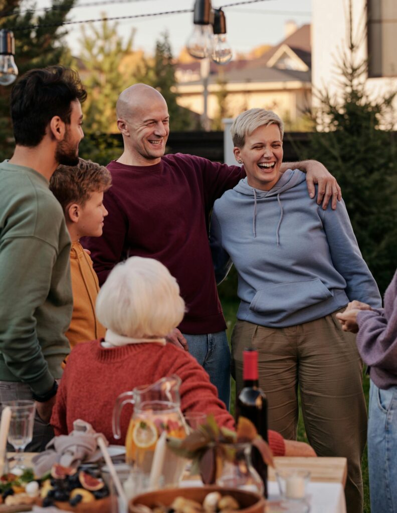 Happy family enjoying a warm outdoor meal together, celebrating love and togetherness.