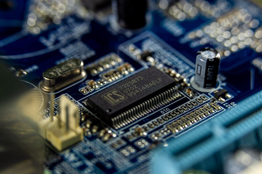 Detailed shot of a microprocessor on a blue motherboard showcasing electronic components.